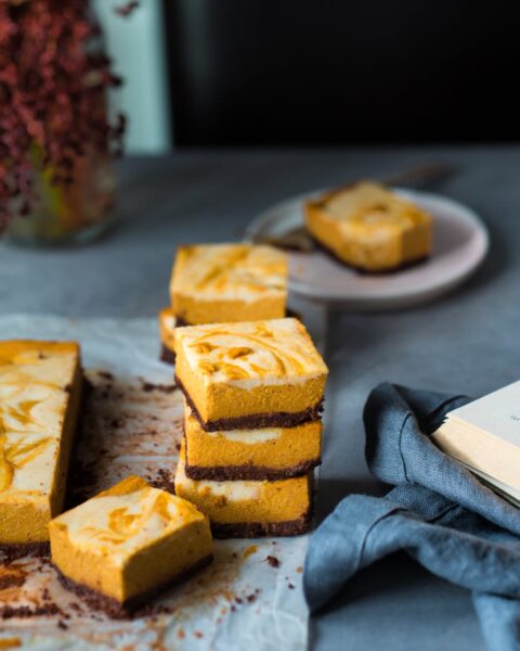 stacked slices of pumpkin cheescake bars