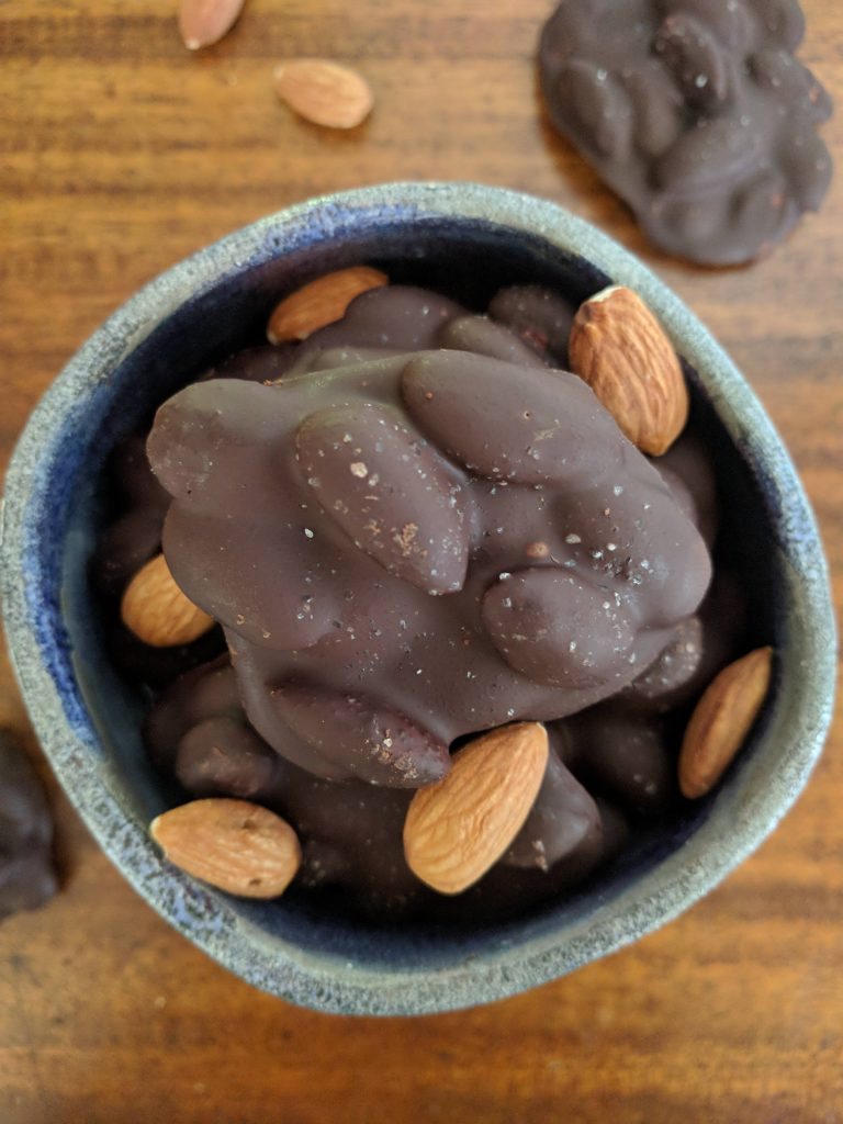 chocolate almond clusters and almonds in bowl
