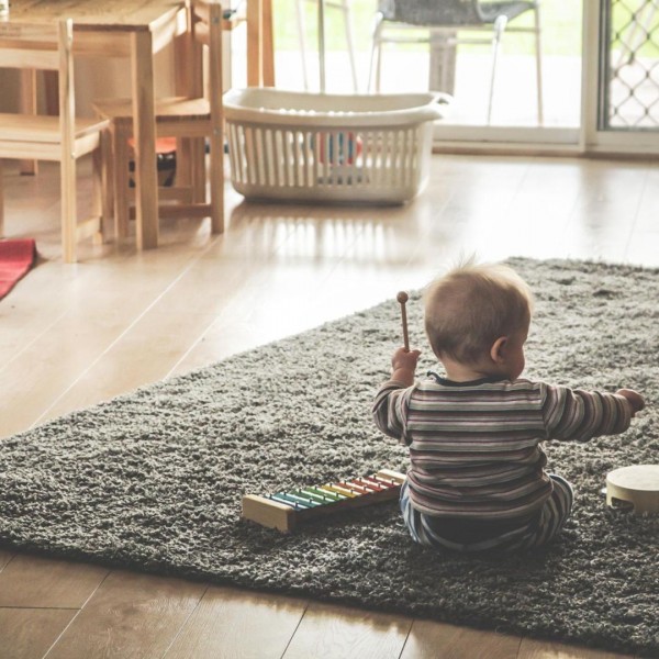 kid playing on rug