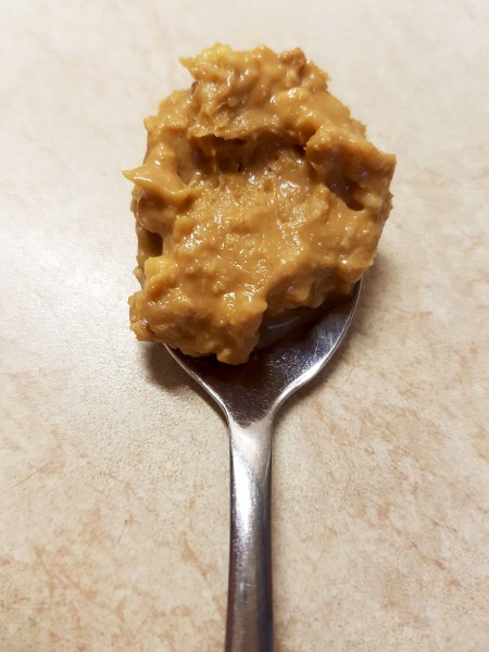 homemade peanut butter on a spoon -  made easily with a food processor.