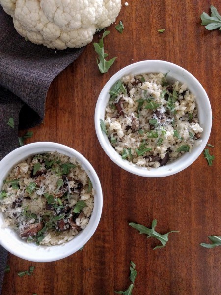 Two ramekins of cauliflower rice with  mushrooms, greens, and Parmesan.