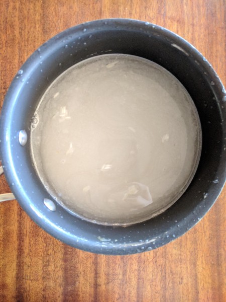 Rice in pot ready for first rinse. The water is pretty cloudy. We want it to get clear.