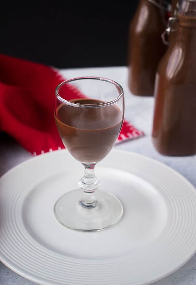 chocolate liqueur in a cocktail glass on a white plate