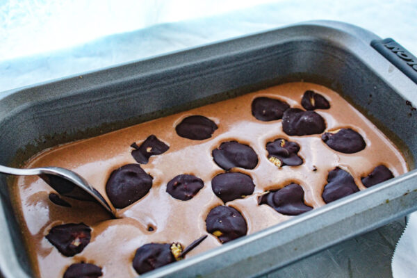Ice cream with chocolate covered peanut butter balls in a loaf pan