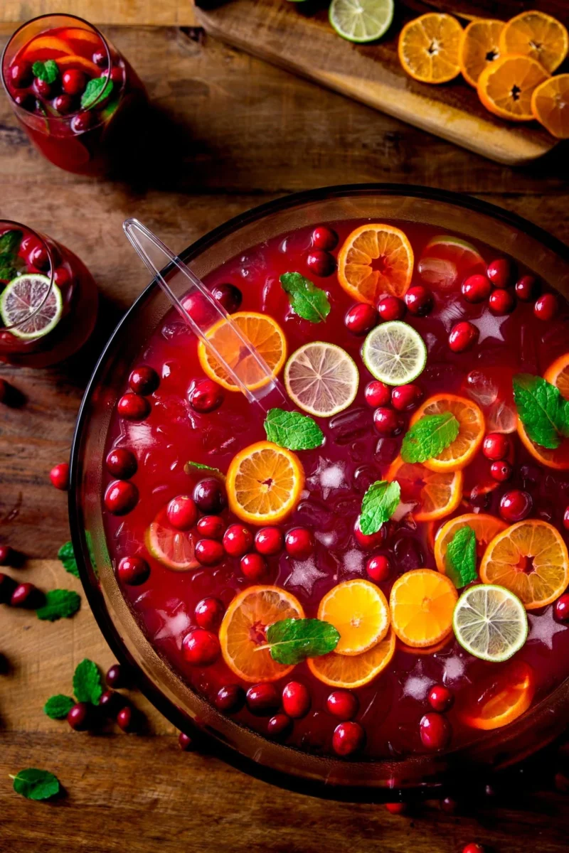 Christmas punch in a punch bowl with cranberries, orange lime and lemon slices, mint leaves 