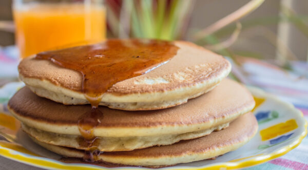 Paleo cinnamon pancakes with orange juice and a honey cinnamon glaze.