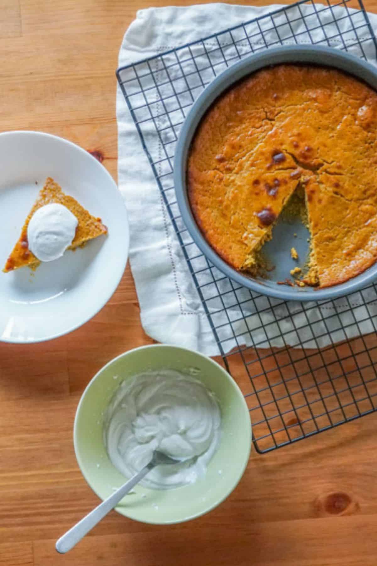 baked whole and  a slice pumpkin pie to with dairy free cream
