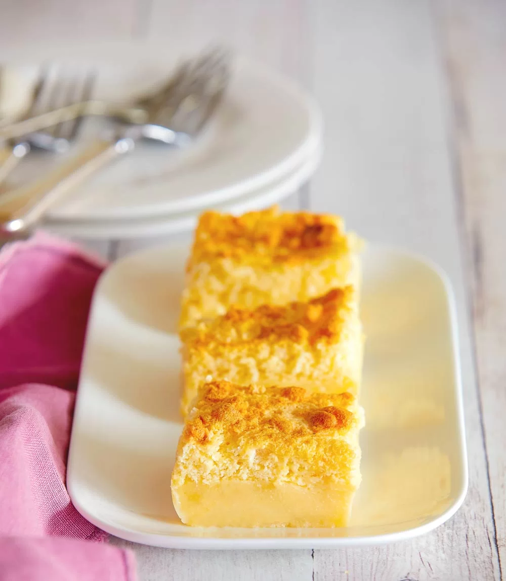 sliced lemon custard cakes on a white rectangular serving plate