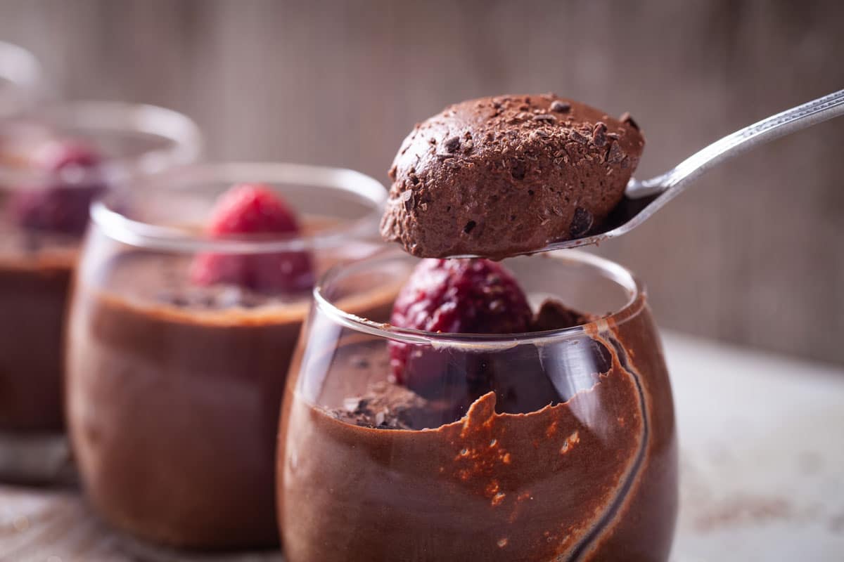 chocolate mousse topped with berries in glasses