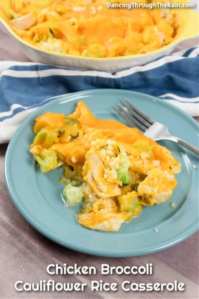 cooked Chicken Broccoli Cauliflower Rice Casserole with a fork on a light blue plate