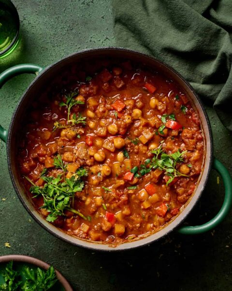 cooked chickpeas  stew with pepper garnish with herbs  in a pot 