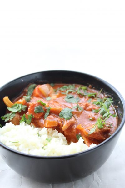 Crockpot butter chicken recipe in bowl.