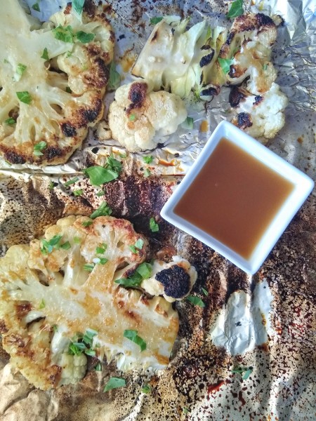 Overhead shot of sesame ginger sauce with grilled cauliflower steaks