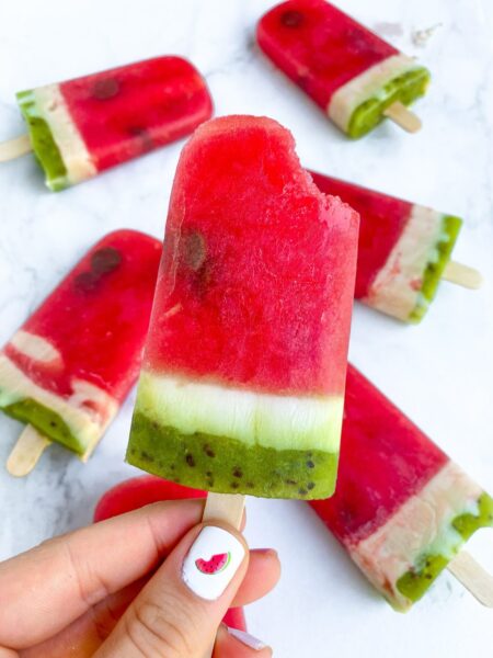 bitten watermelon popsicle in the appearance of a watermelon with colors red, white and green