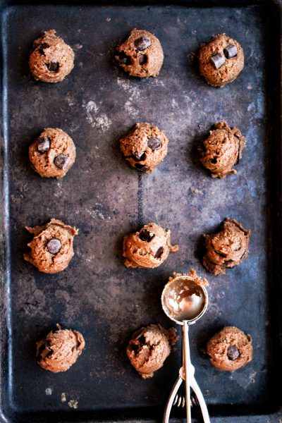 Balls of ginger cookie dough on a cookie sheet
