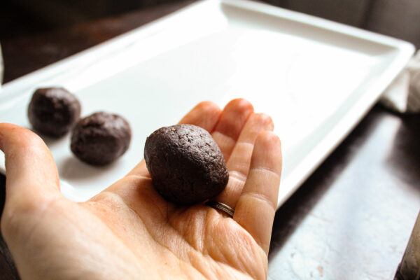 Rolled brownie balls in hand