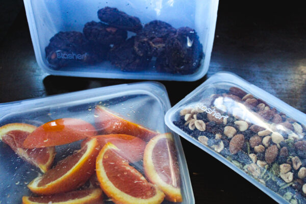 Stasher snack & sandwich bags with trail mix & oranges inside