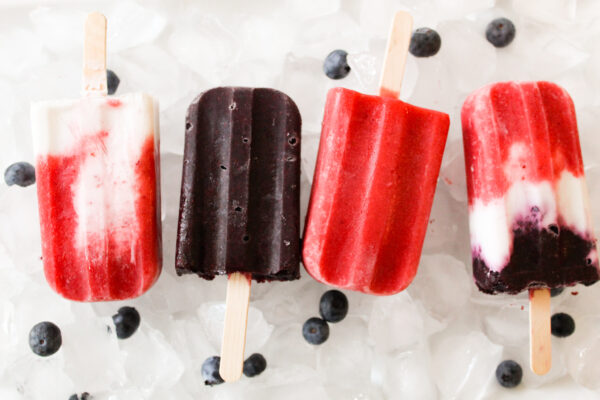 real fruit dairy popsicles served over ice cubes with fresh blueberries 