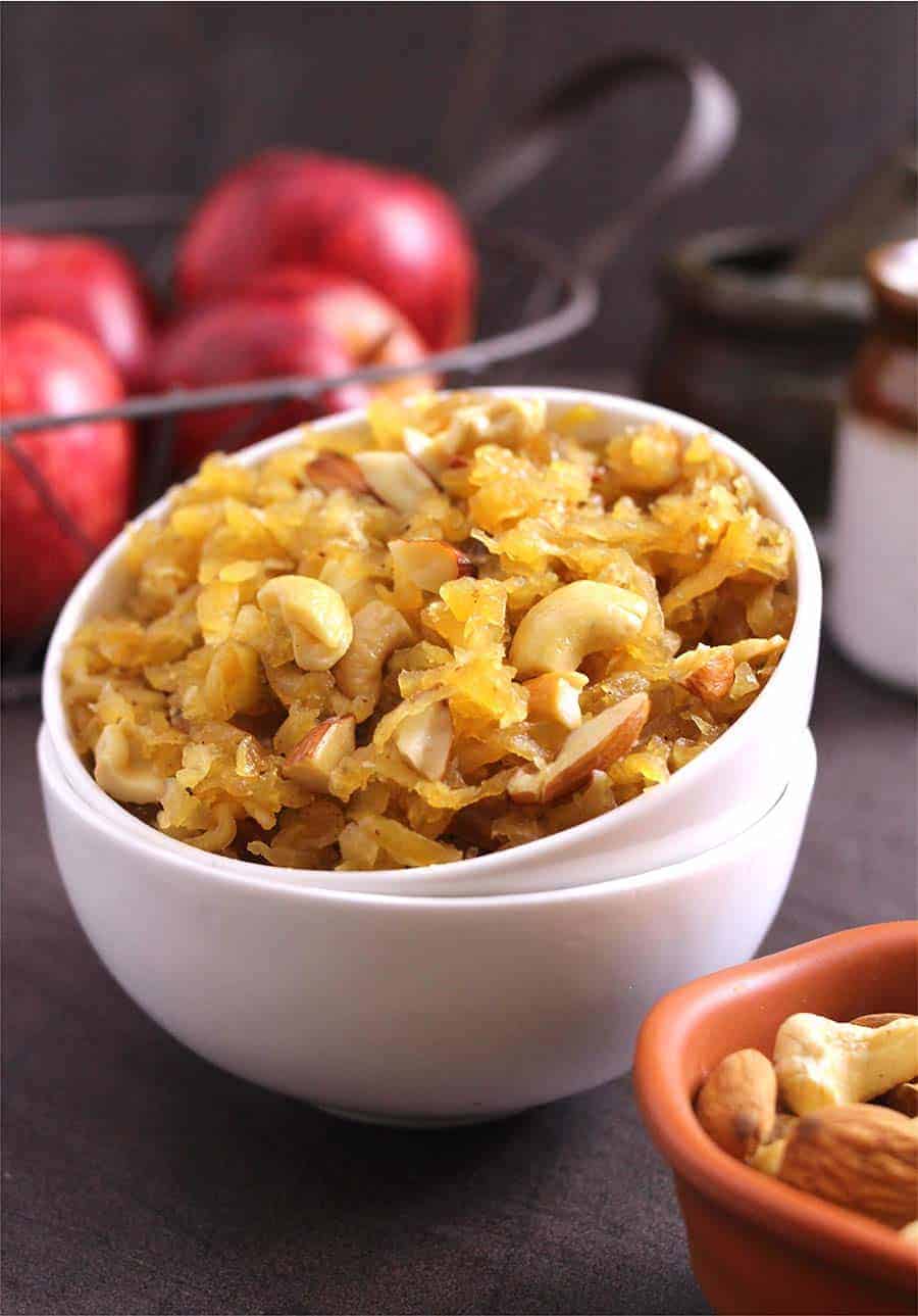 apple budding with roasted nuts in a white small bowl 