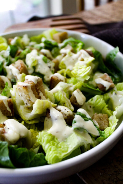 close up view of caesar salad in white bowl