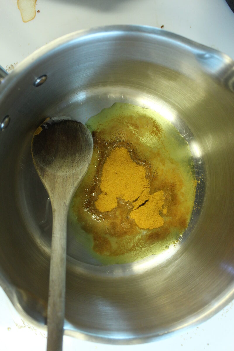 step 1 - curry powder and coconut oil in pan