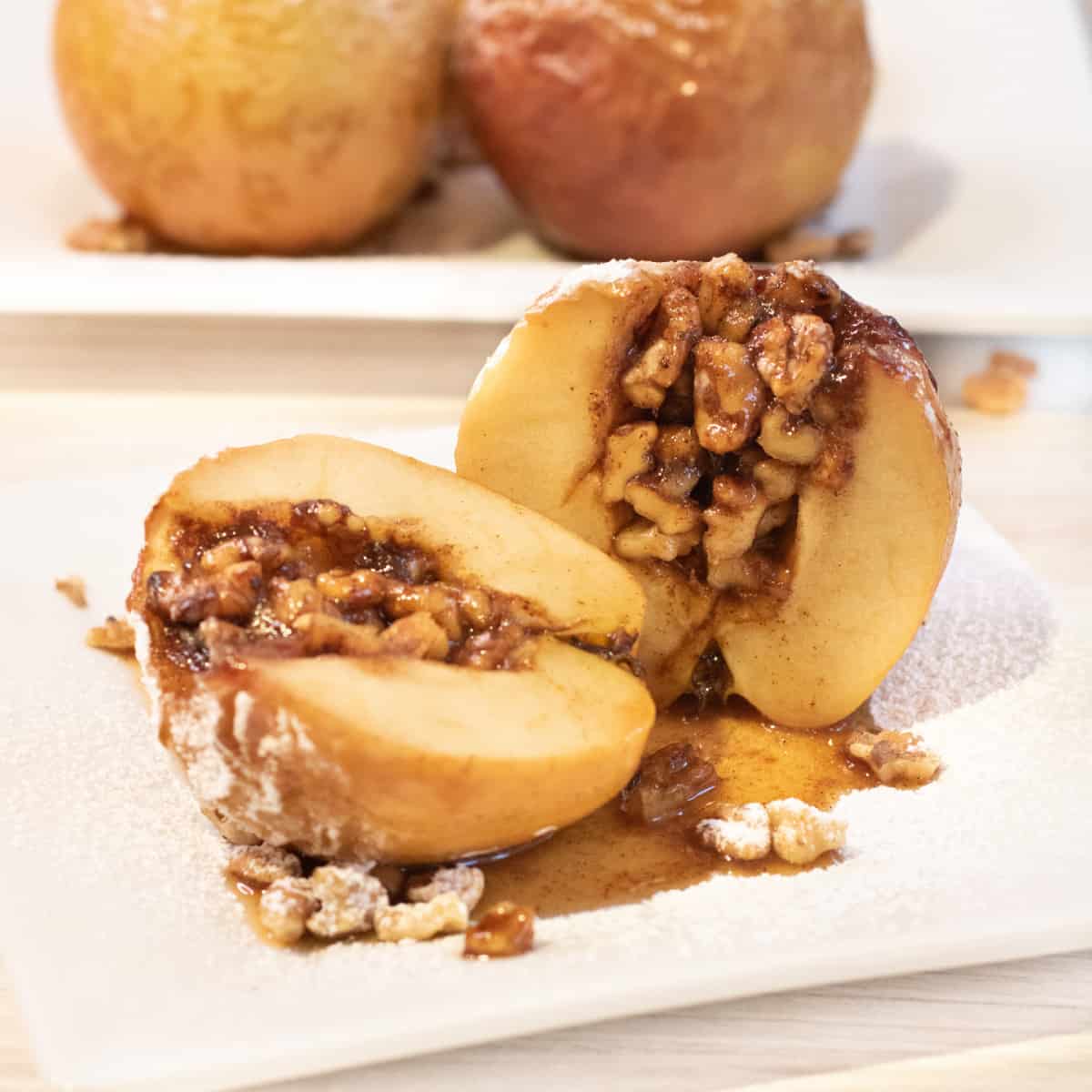 halved bake apples stuffed with walnuts and cinnamon