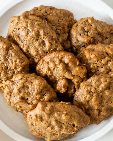 baked orange almond butter oatmeal cookies on a white plate