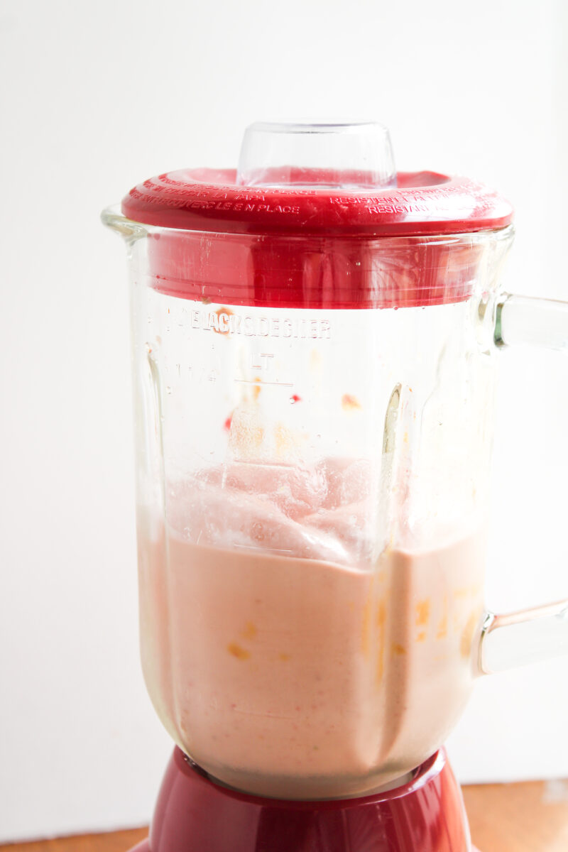 PB&J Smoothie blended in a red and clear blender.