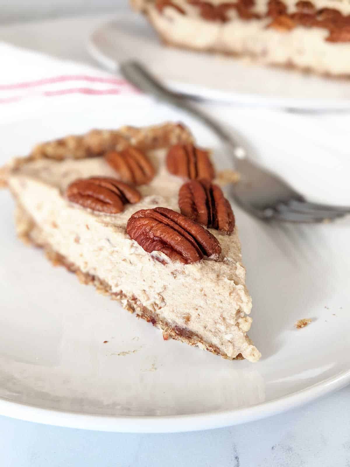 a slice of pecan cream pie on a white plate