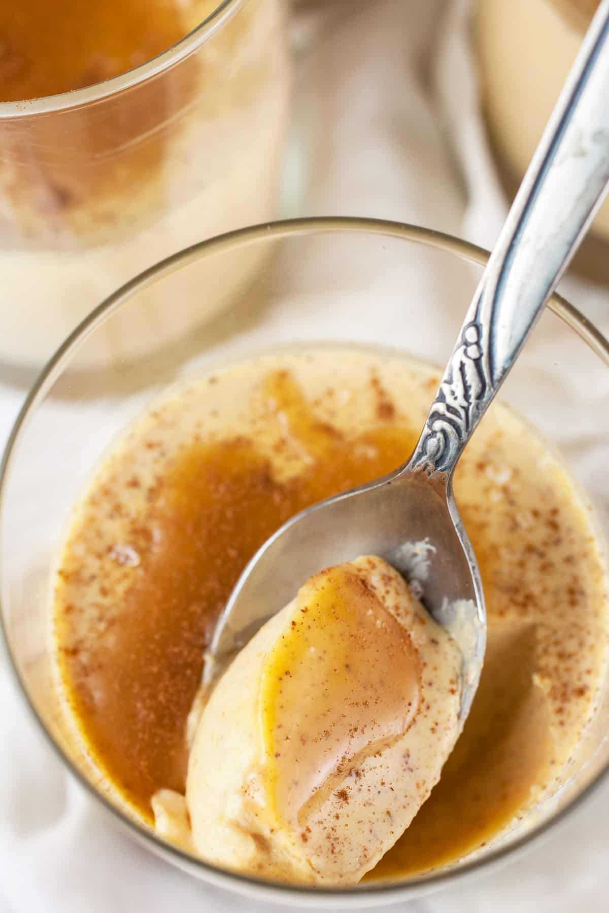 pumpkin panna cotta in a glass with a spoon