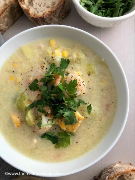 creamy Smoked Haddock & Prawn Chowder garnish with herbs in a white bowl