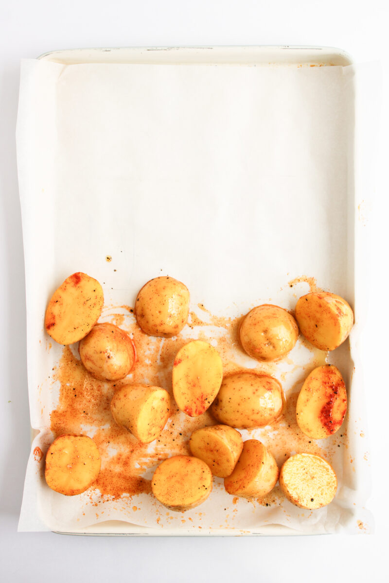 Seasoned potatoes arranged on lower 3rd of baking sheet