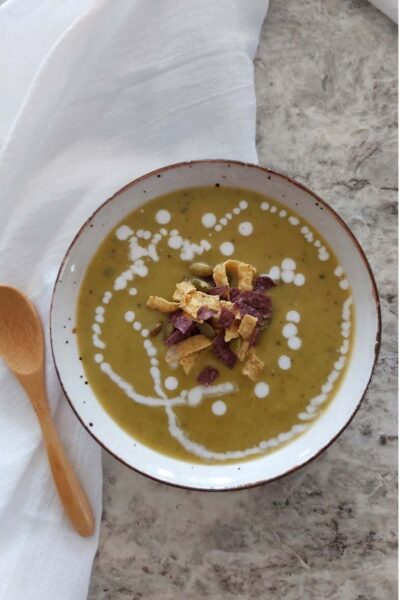 Thai Pea soup in a bowl with coconut milk dripped on top