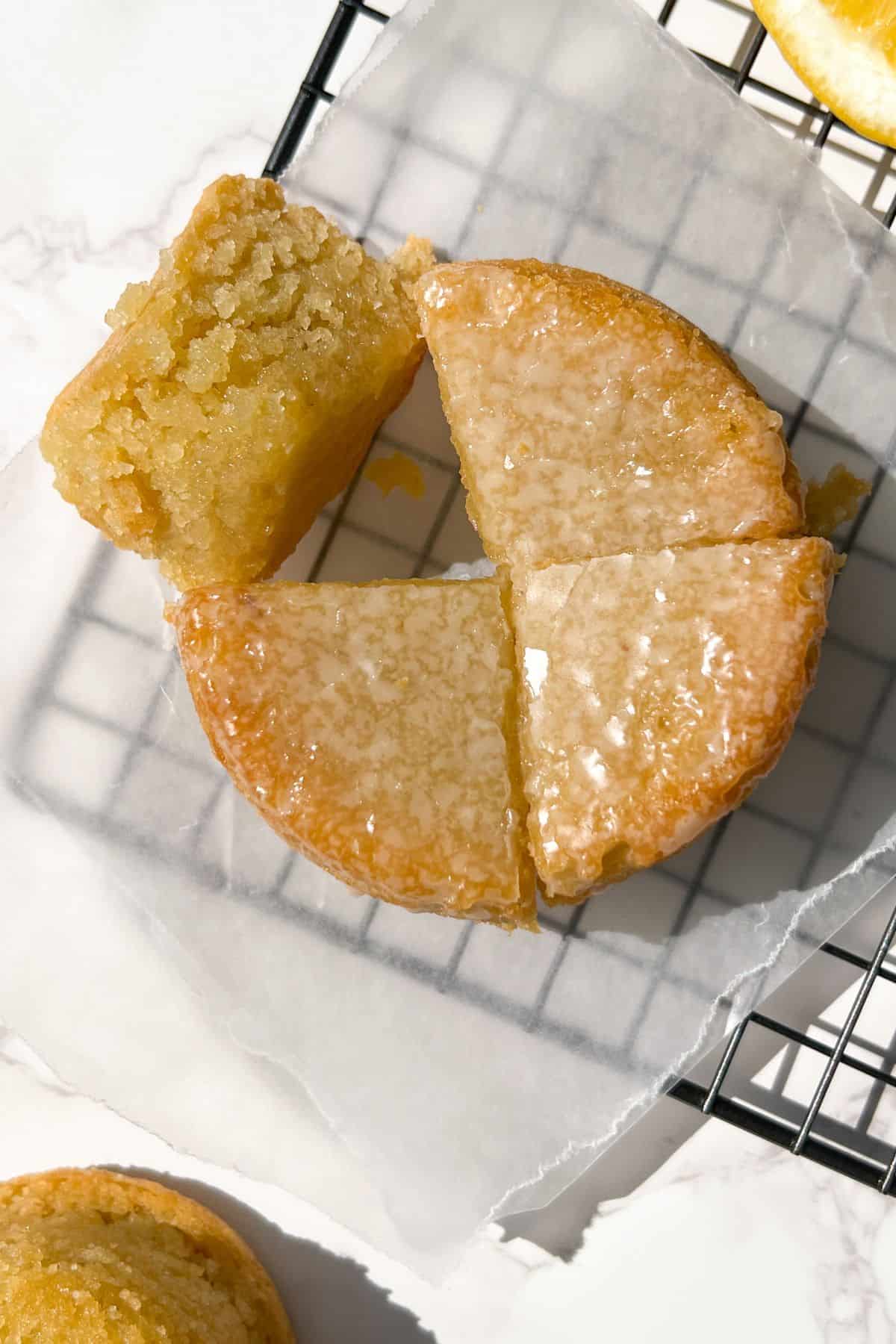 sliced vegan olive oil cake on a white parchment paper on a cooling rack