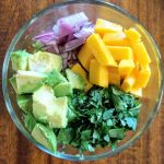 Avocado Mango salsa in glass bowl. An easy and delicious dip.