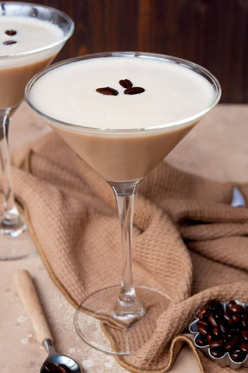 Bailey's espresso martini with coffee beans in a martini glass with white cloth