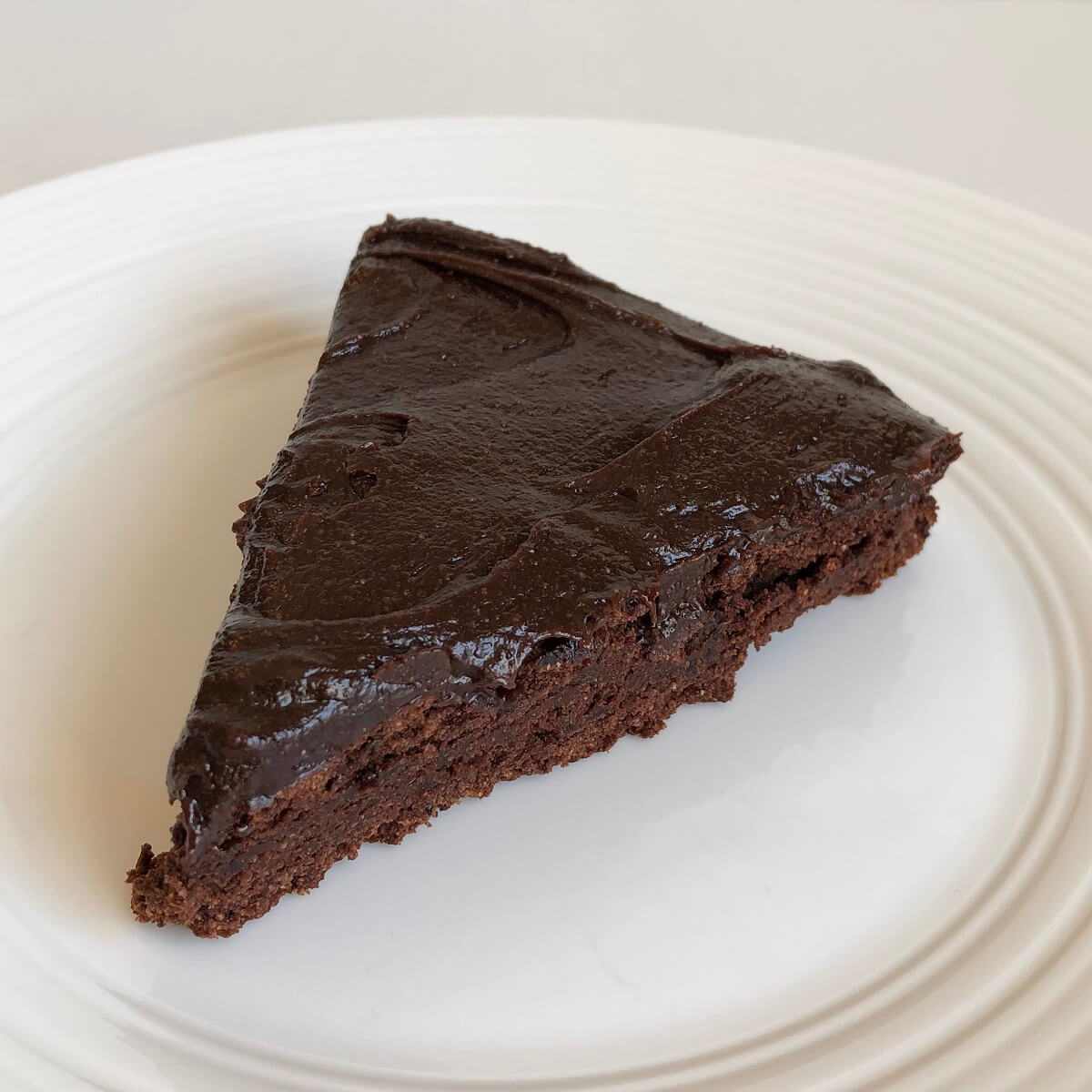a slice of chocolate black bean cake on a white plate