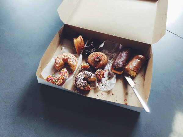 A box of doughnuts half eaten as you'd see in your office.