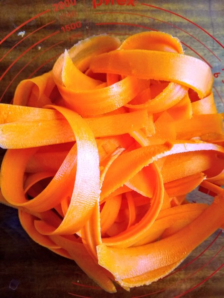 Peeled carrot noodles in a bowl