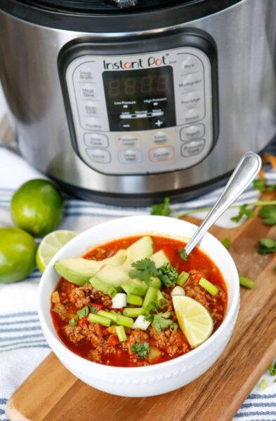 chili with meat/ground beef, veggies and spices in a white bowl