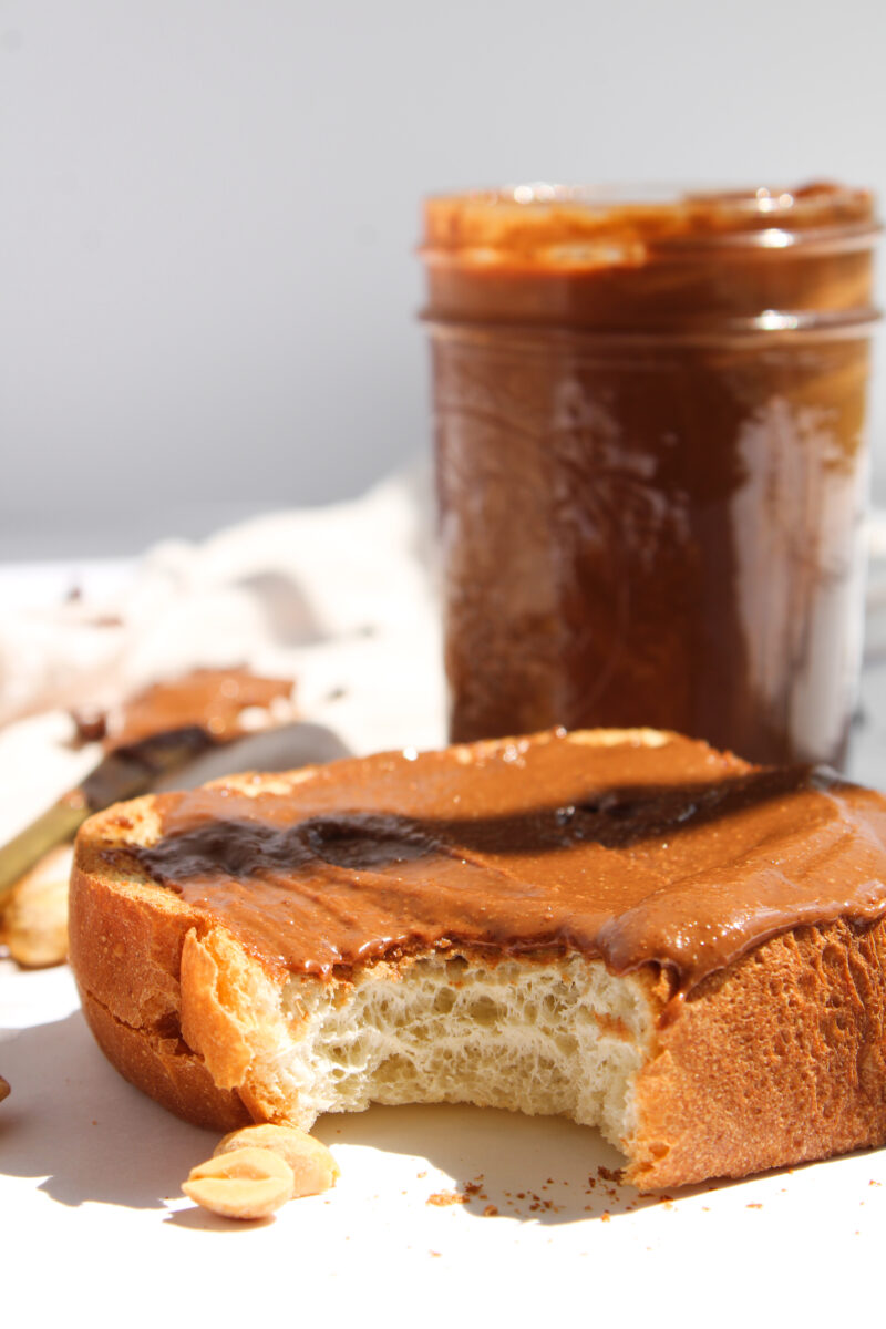A bite is taken out of toast with chocolate peanut butter toast.