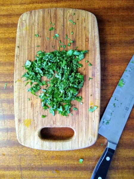 chopped cilantro on cutting board ready to go in the cilantro lime mayo