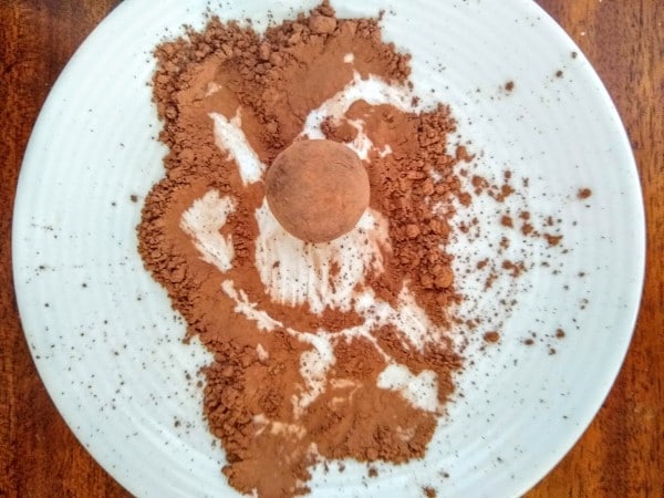 Dip the balls in cocoa powder and roll between hands to coat.