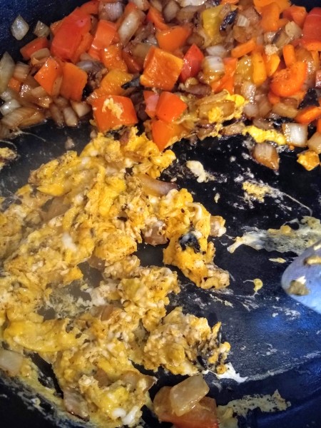 scramble the egg with the veggies