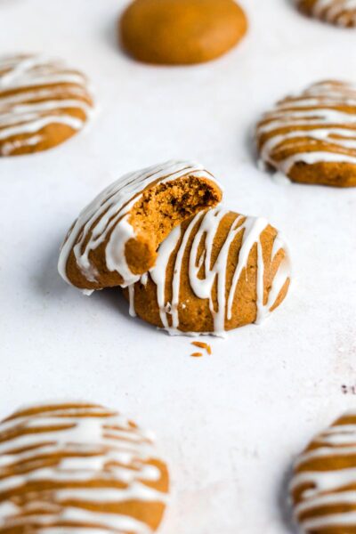 bitten pumpkin cookie and pumpkin cookies with vanilla white glaze