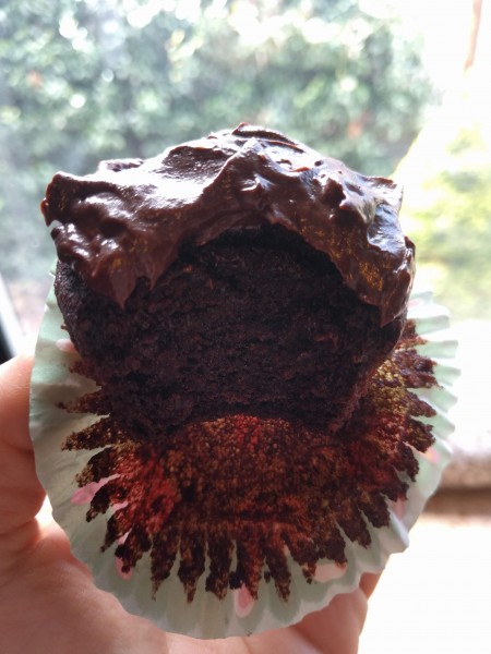 A dark chocolate cupcake with chocolate avocado frosting. 