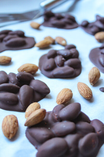 dark chocolate covered almonds on parchment paper