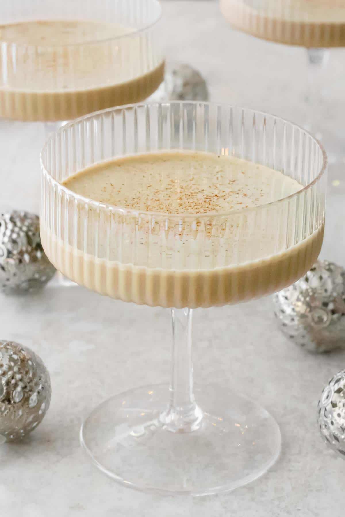 homemade eggnog with liquer and no raw eggs in cocktail glass topped with cinnamon