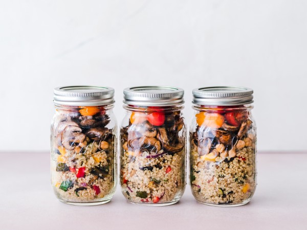 Three salads in jars on table. Meal prepped and ready to go.