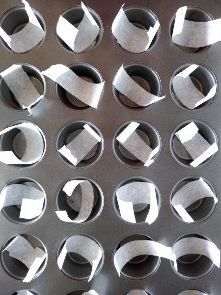 Mini muffin tin lined with parchment strips